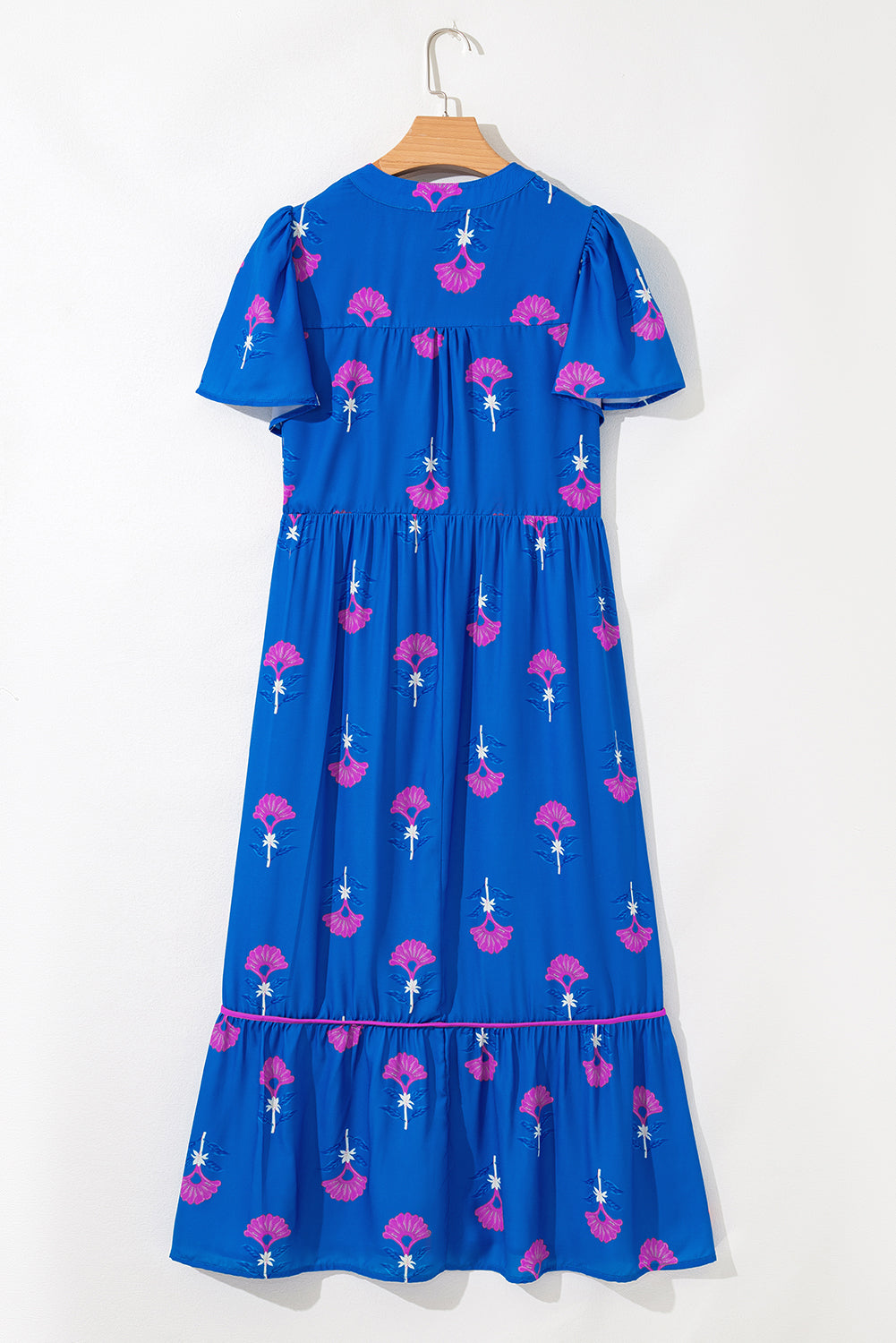 Blue dress with pink floral pattern on a white background