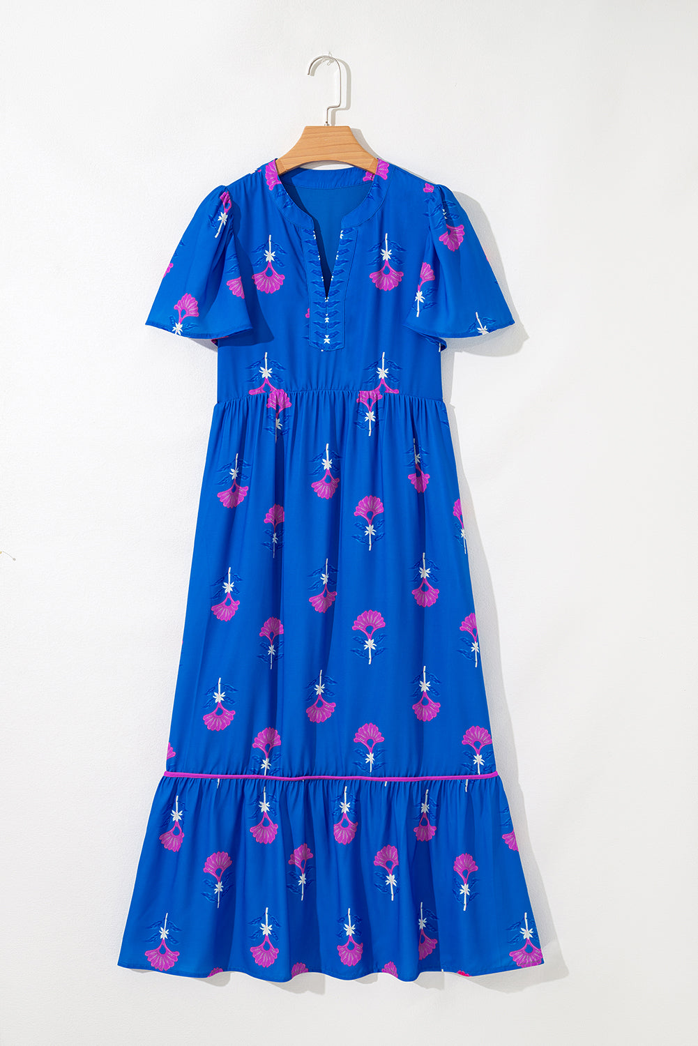 Blue dress with pink floral pattern on a white background