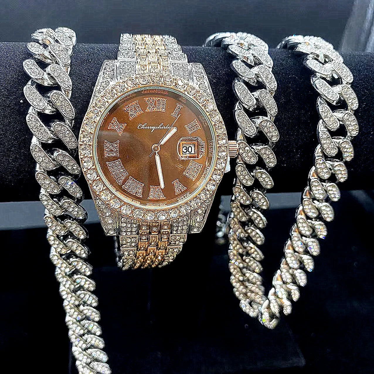 Luxury watch with diamond-studded chain on a black background