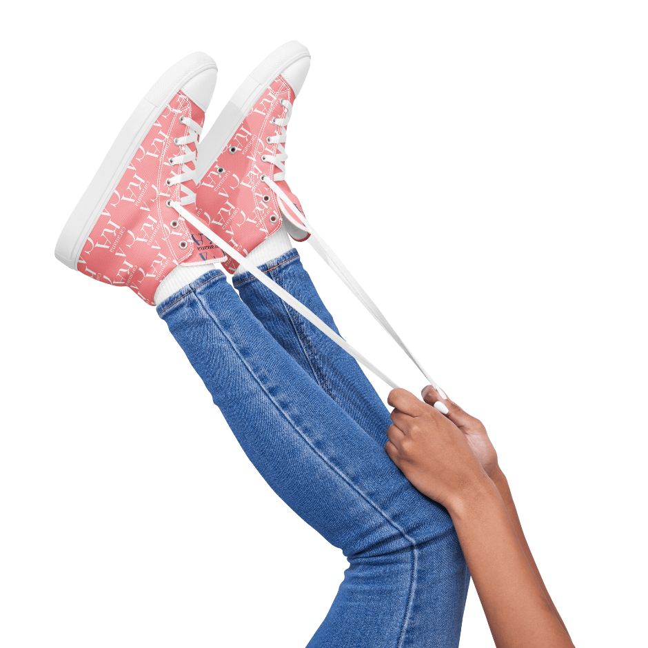 Person wearing pink sneakers with white soles and blue jeans on a white background