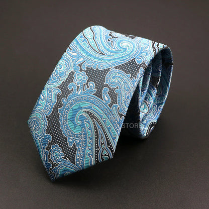 Blue paisley patterned tie on a dark background