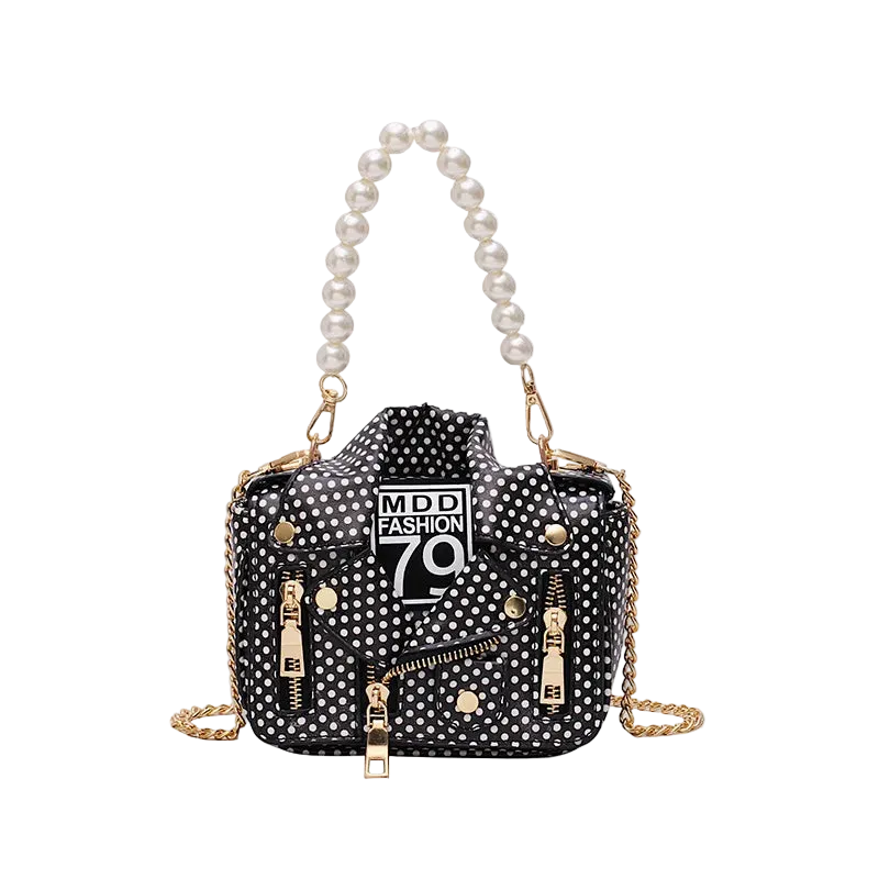 Black polka dot handbag with pearl handle and gold chain on a white background
