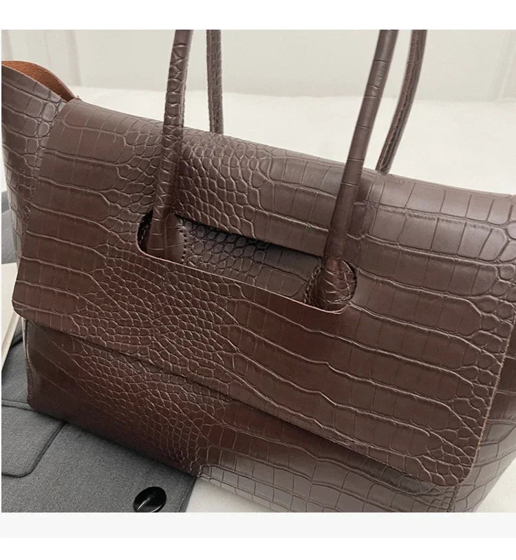 Carauana Crocodile Leather Handbag BROWN on a light gray background