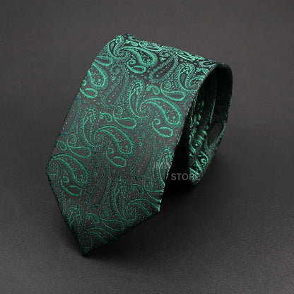 Green paisley patterned tie on a dark gray background