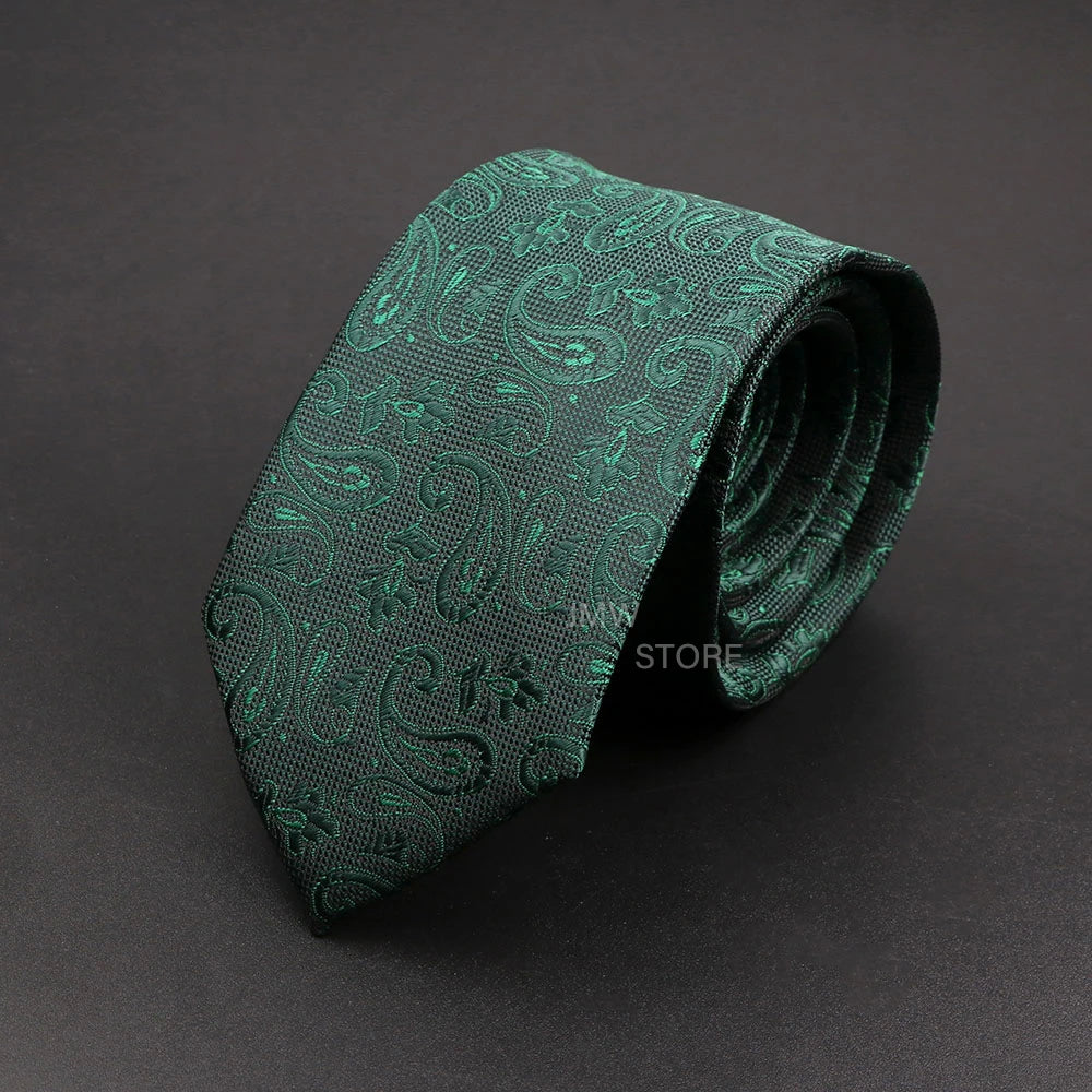 Green paisley patterned tie on a dark gray background