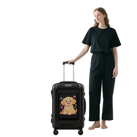 Person holding a black LOY Trolly Smart Suitcase - LED Programmable Smart Luggage with a cartoon dog design