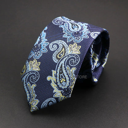 Navy blue paisley patterned tie on a dark background