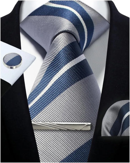 Blue and gray striped tie with matching cufflinks and tie clip on a black suit jacket.