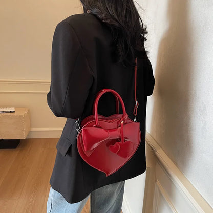 Person wearing a black outfit with a redcarauana-lovely-shoulder-bag-heart