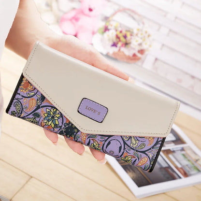 purple wallet with floral design and 'LOVE'S' branding.